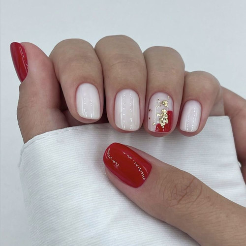 White manicure with red accent