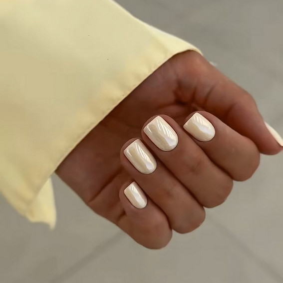 Pastel yellow manicure with a pearlescent effect